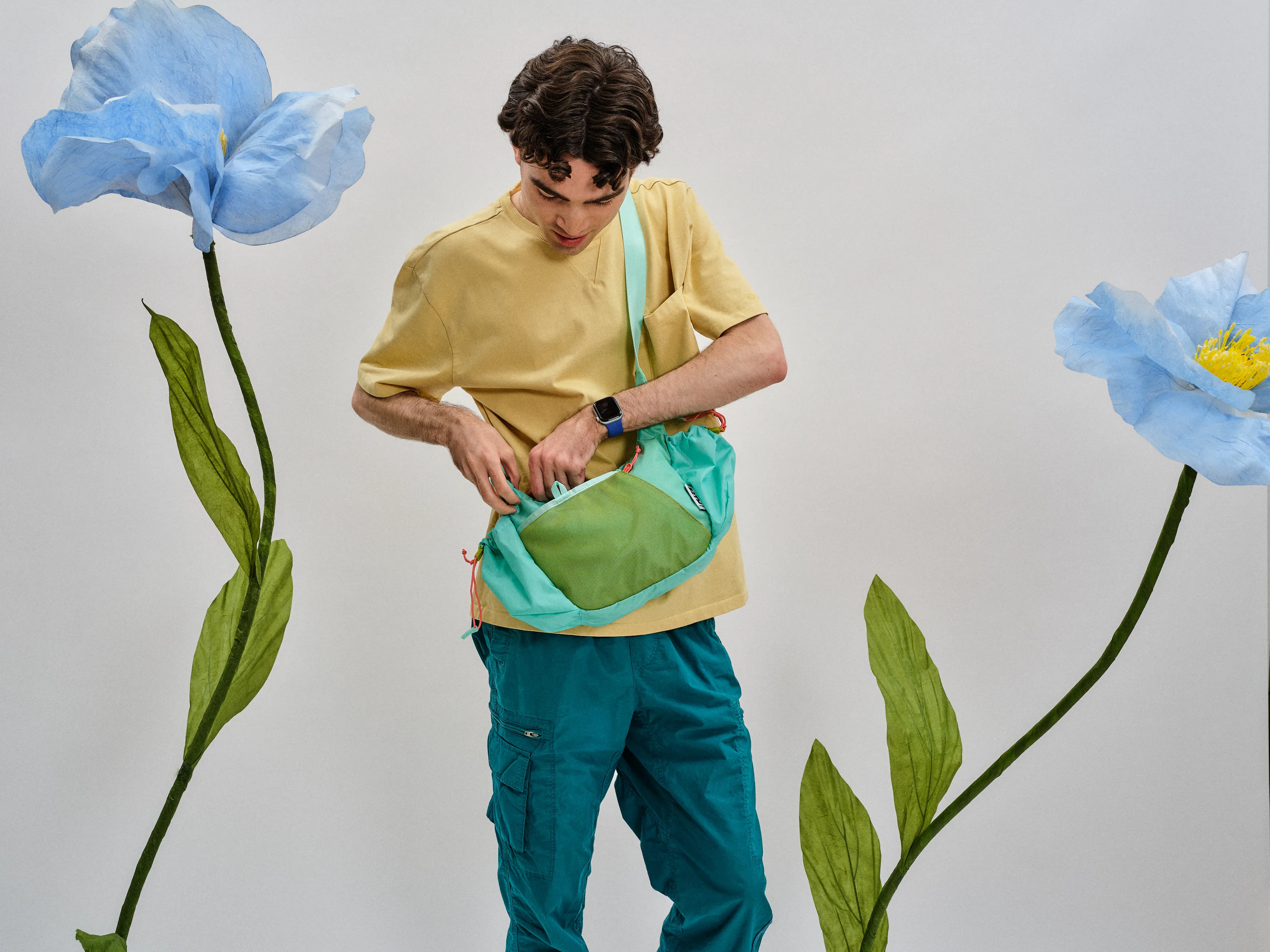 Lachlan wearing a crescent-shaped bag