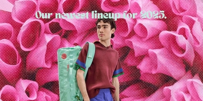 Lachlan looking into the distance wearing a bright turquoise backpack