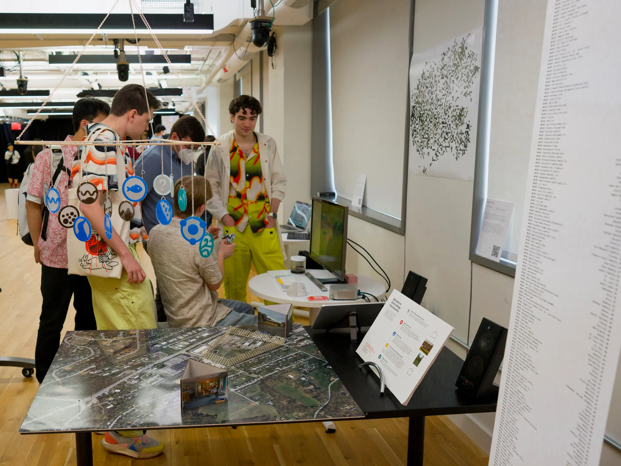 Group of visitors standing behind the mobile, map, and timeline