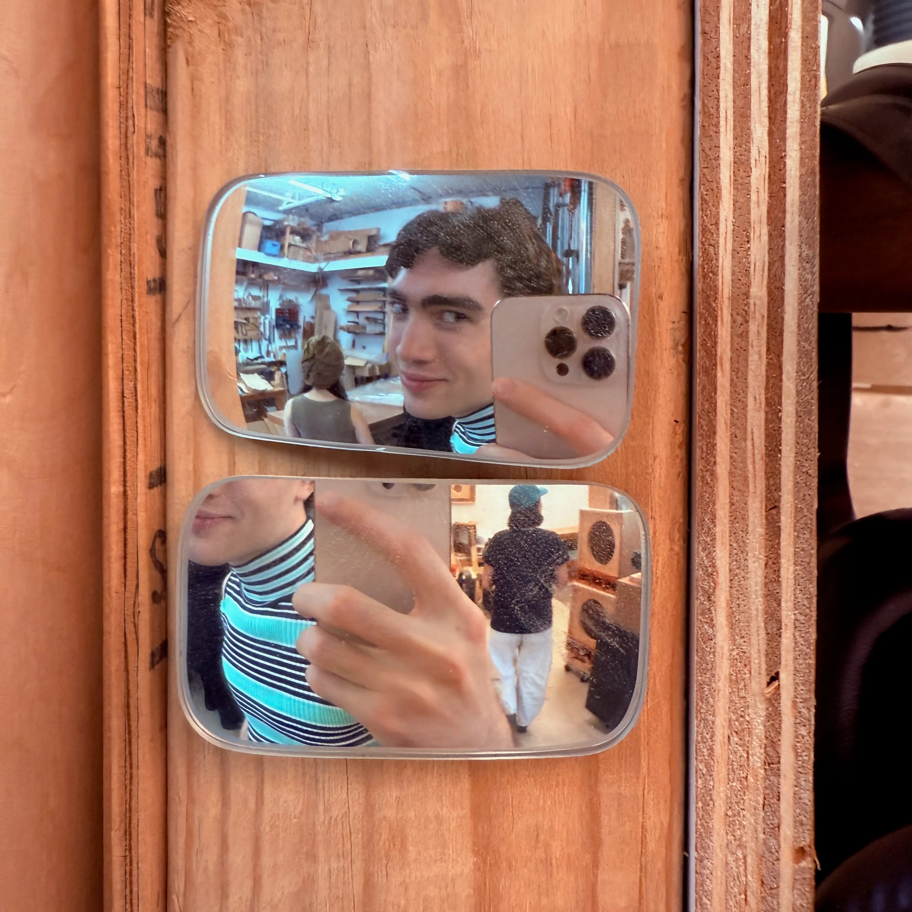 Mirror selfie of Lachlan in a green shirt in a woodshop